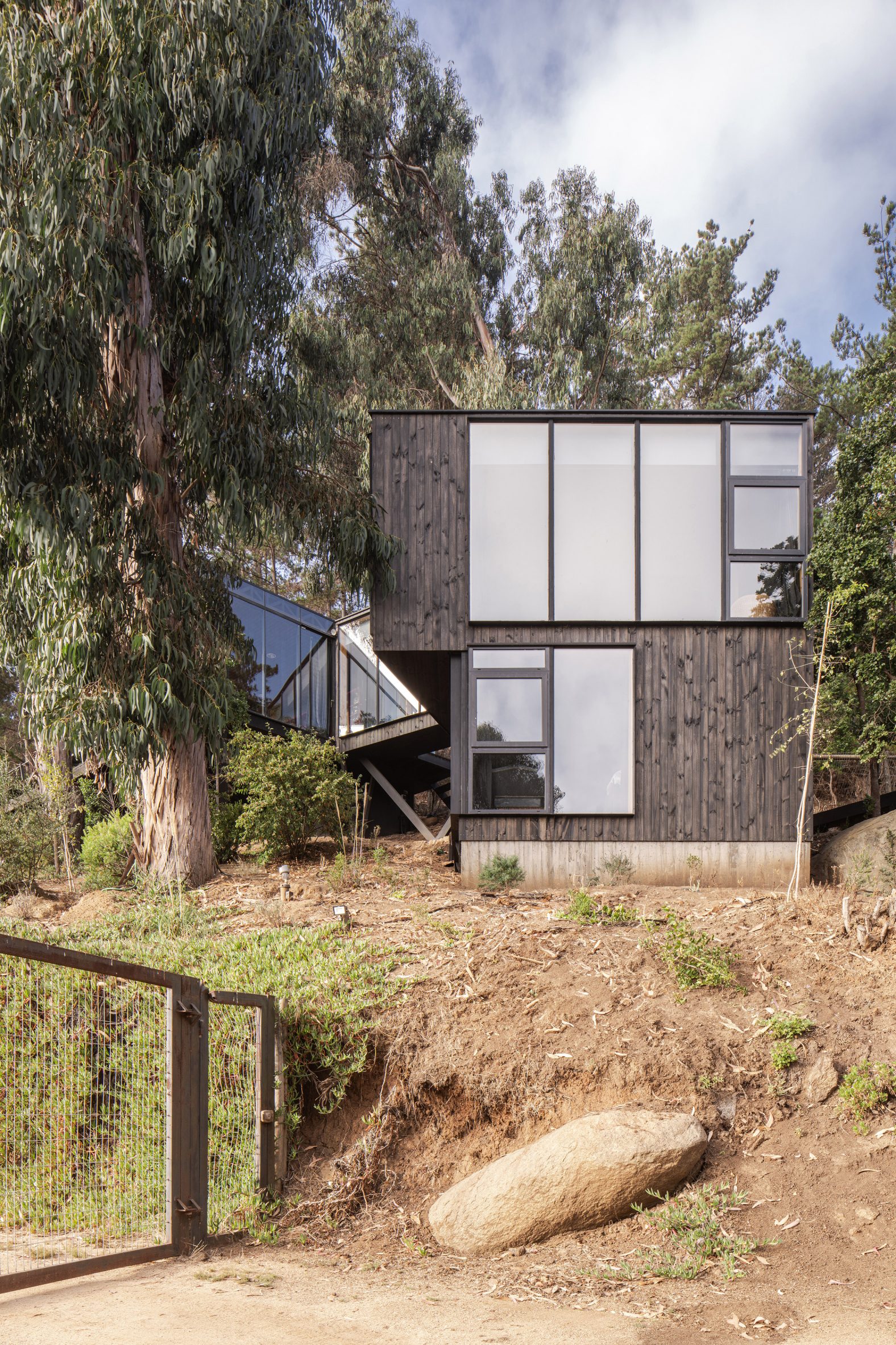 Black-clad house in Chile steps down hillside