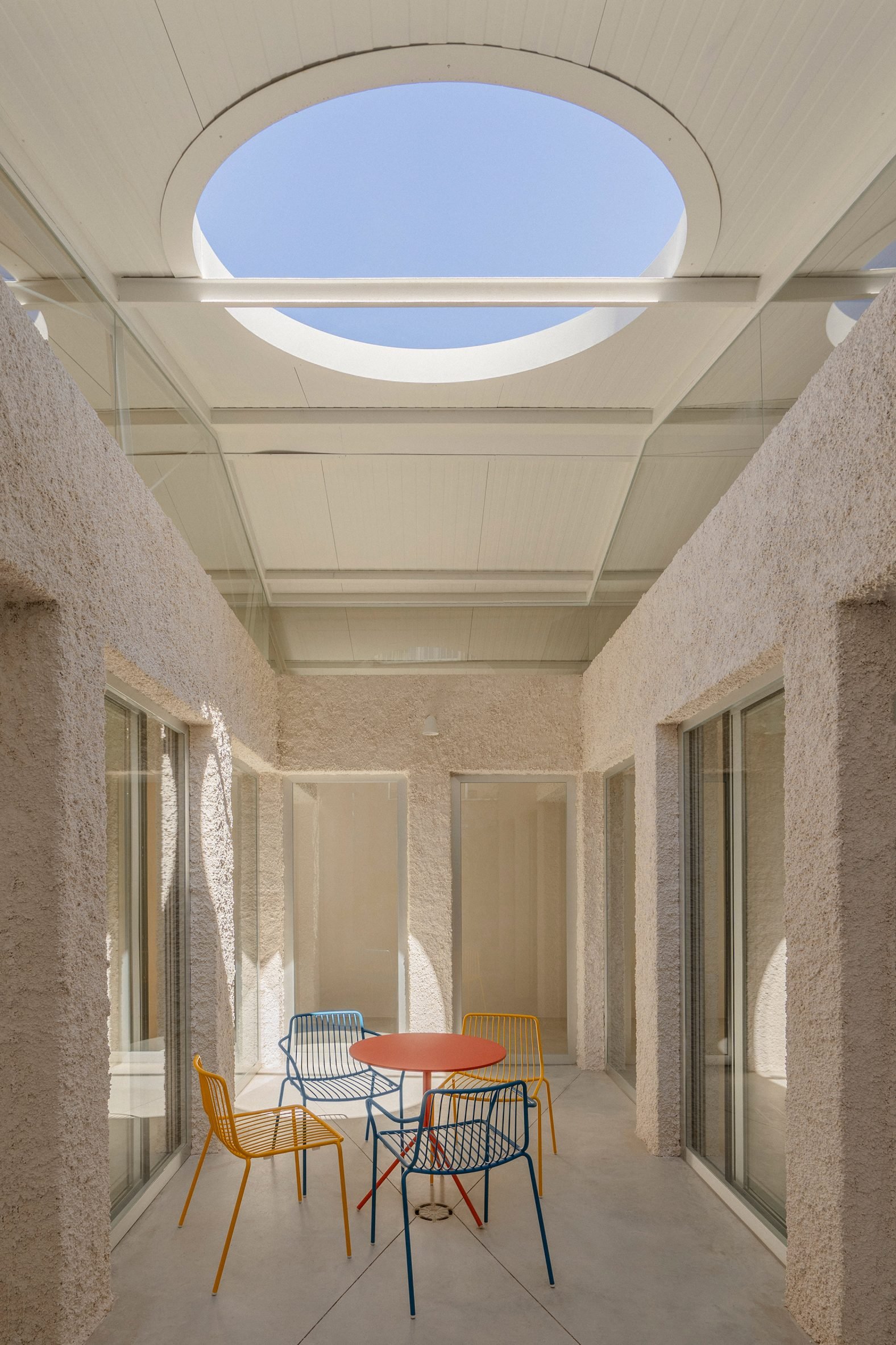 Courtyard with seating at Madrid warehouse conversion by Burr Studio