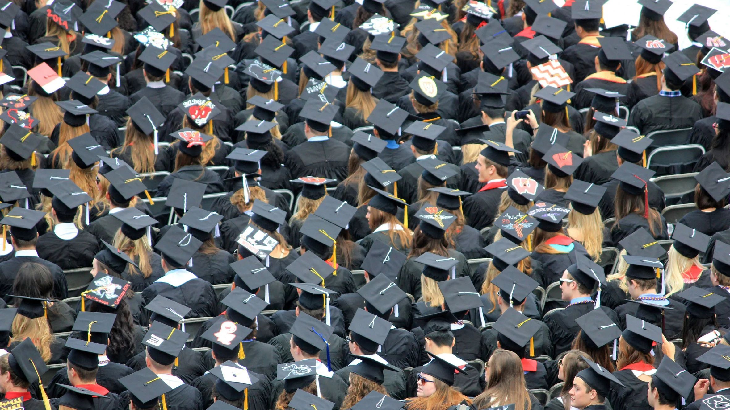 Sea of university graduates in mortar-boards