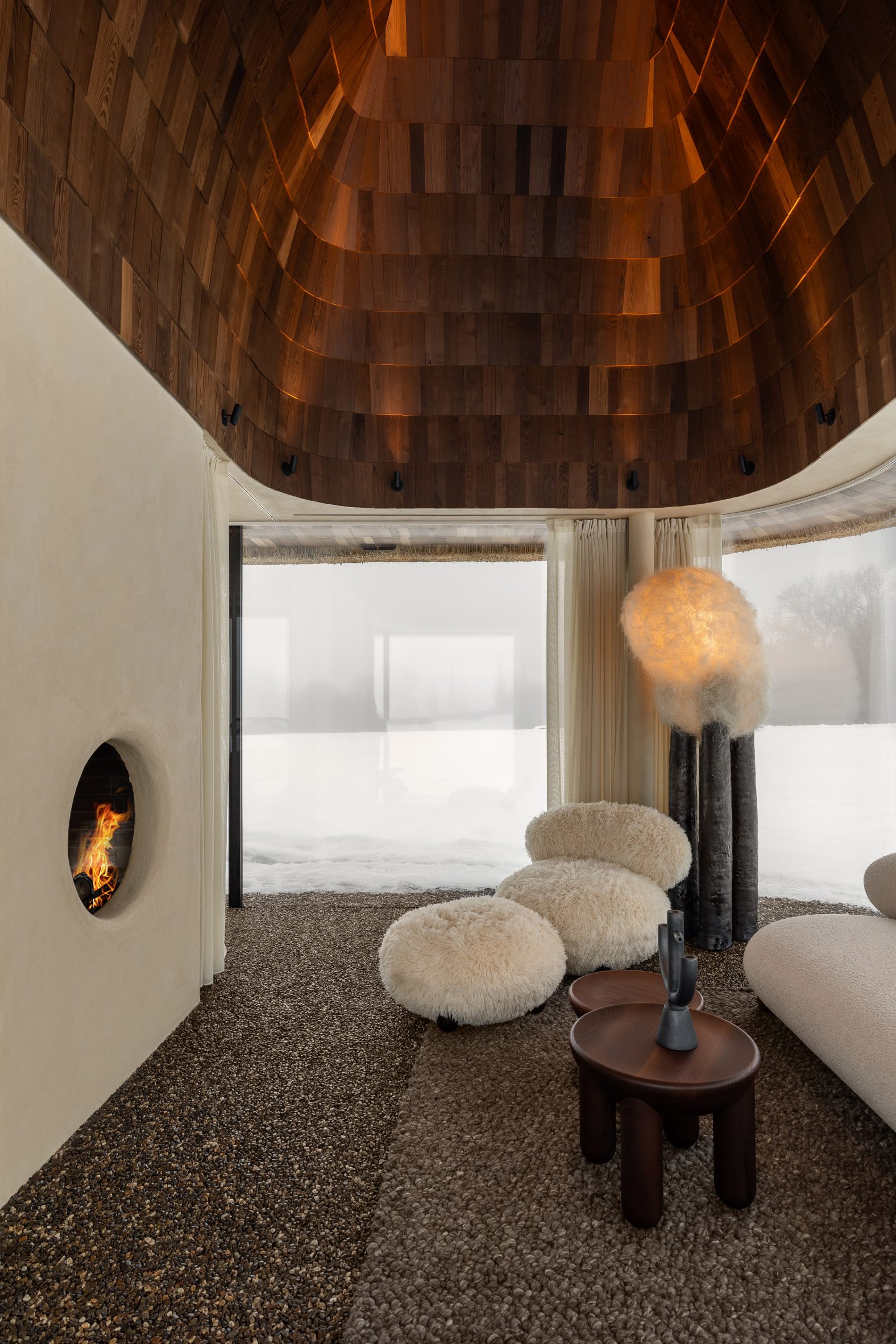 Neutral interior inside glass-walled hut