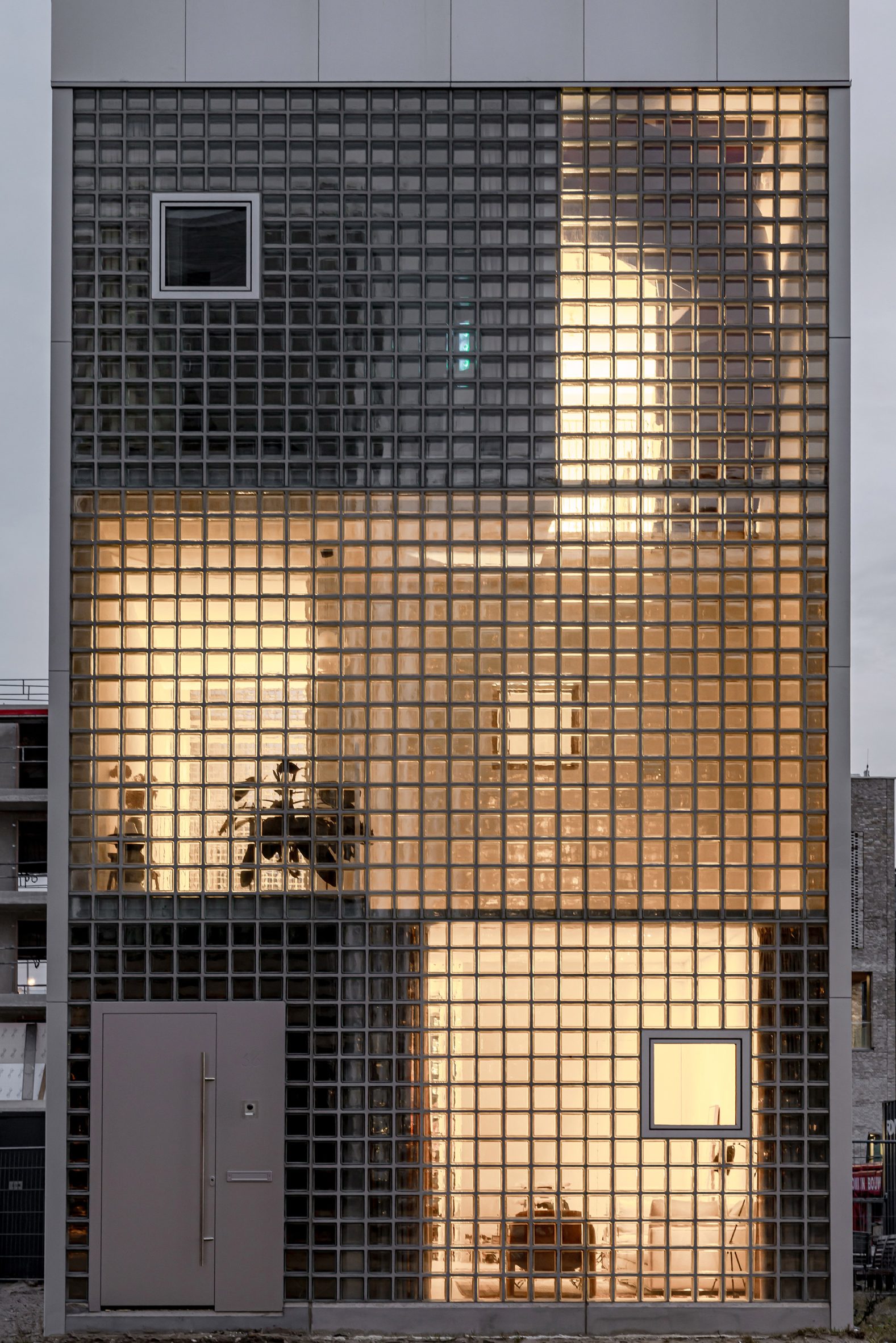 Front facade of glass brick home by Studioninedots