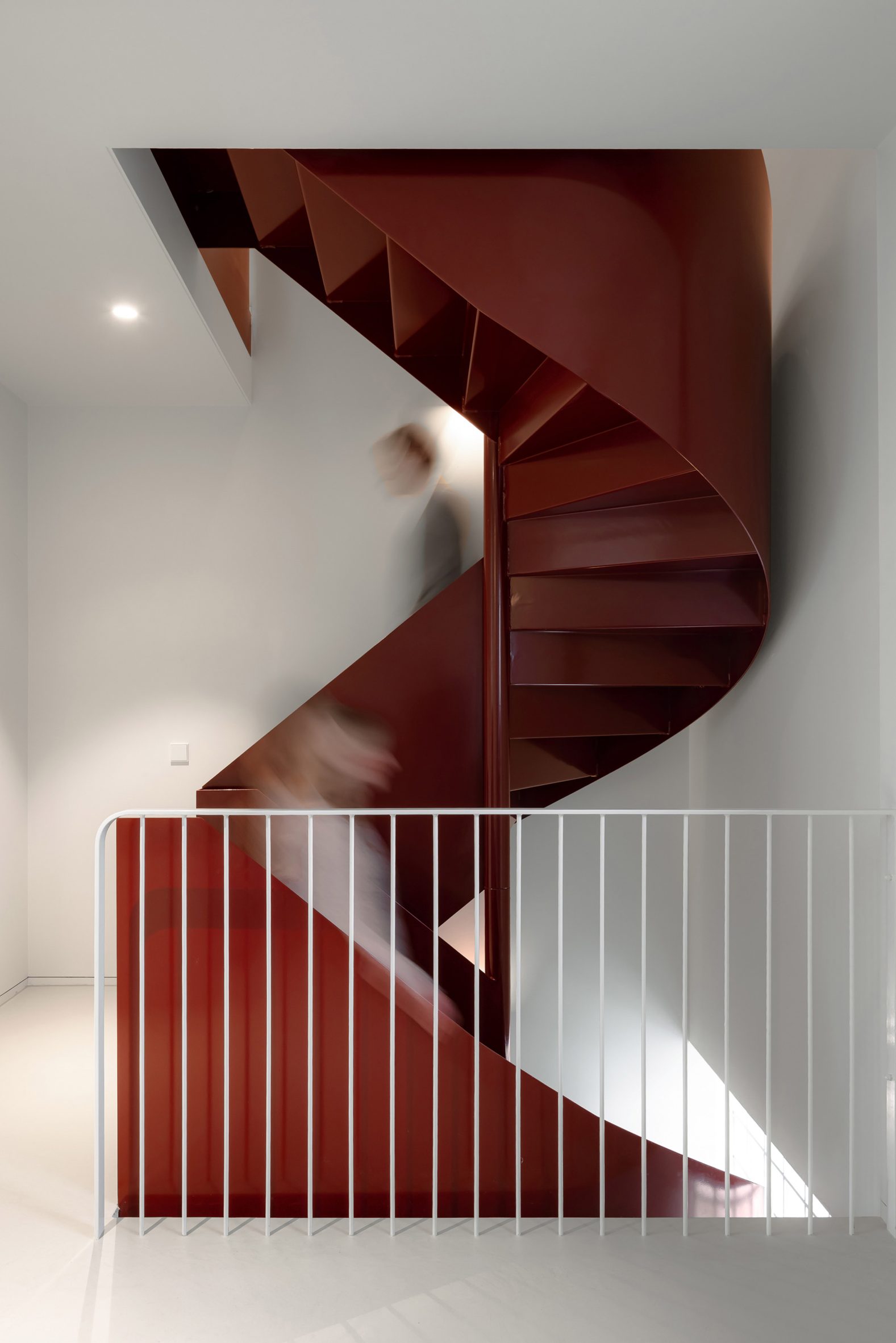 Spiral staircase within glass brick home by Studioninedots