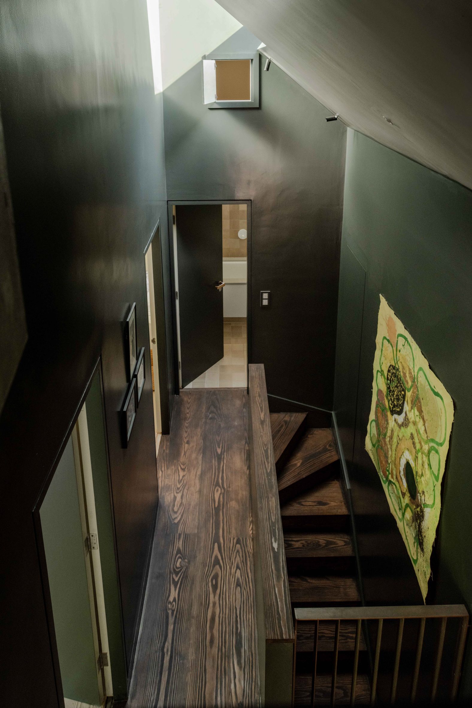 A dark green staircase leads to new extension of Oxfordshire bungalow