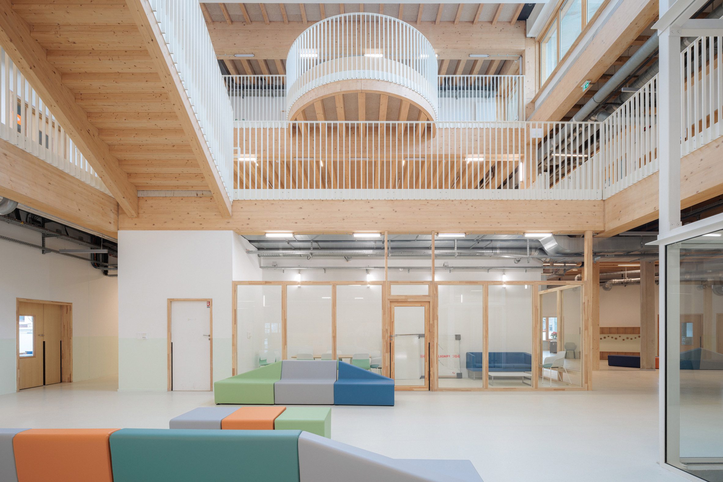 Interior view of the atrium showing timber structure, balconies and communal spaces